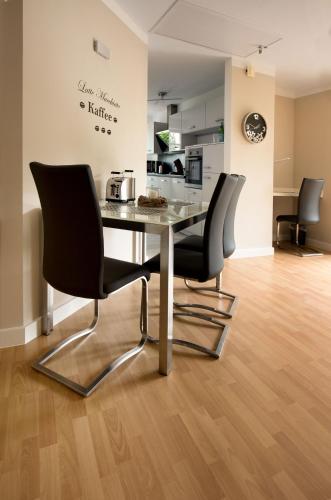 a dining room with a table and two chairs at Luxury Apartment Kampe in Stemwede