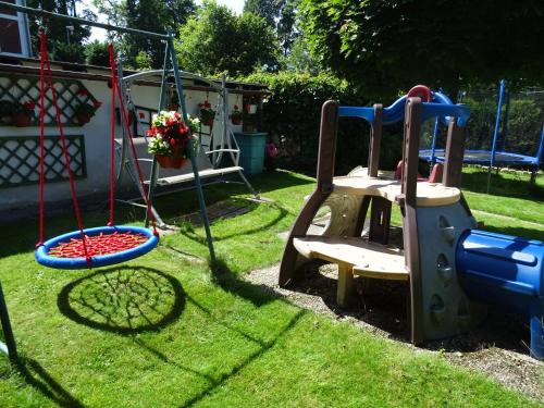 a playground in a yard with a swing at Penzion Pokorny in Jablonec nad Nisou