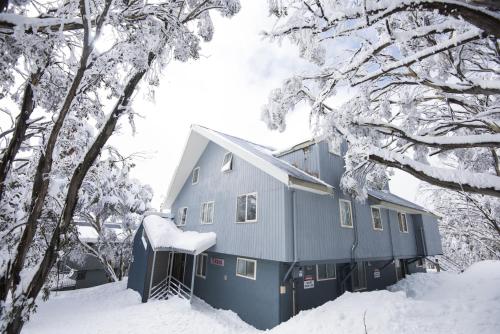 a house in the snow with snow covered trees at TERAMA Ski Lodge in Mount Buller