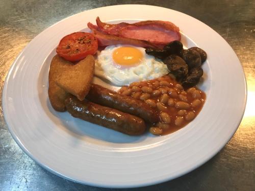 a plate of breakfast food with eggs beans and bacon at The Brotherswater Inn in Patterdale