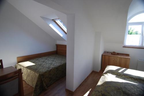 a bedroom with two beds and a window at Ivanek guest house in Zvíkovské Podhradí