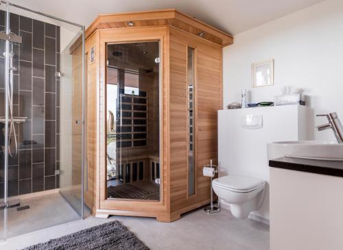a bathroom with a shower and a toilet and a sink at Þrándarholt in Hrepphólar