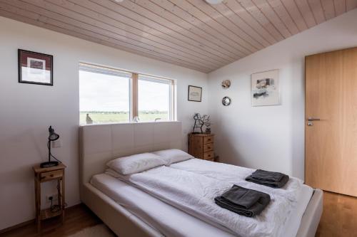 a bedroom with a bed and a window at Þrándarholt in Hrepphólar