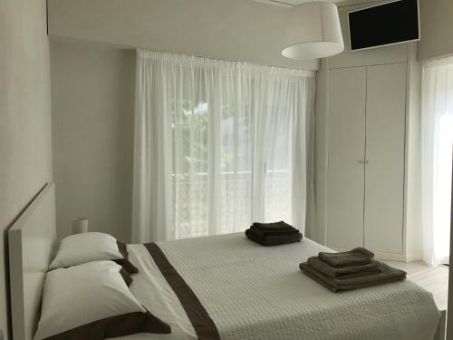 a bedroom with a bed with two towels on it at Stunning Apartment 300mt from the beach in Forte dei Marmi