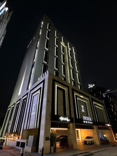 a tall building with lights on it at night at Ischia Hotel in Yongin