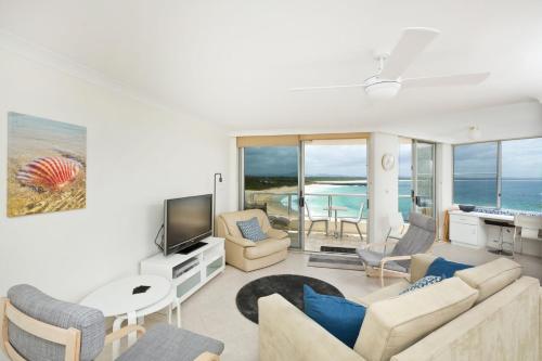 a living room with a couch and a tv at Beachpoint Unit 501 in Forster