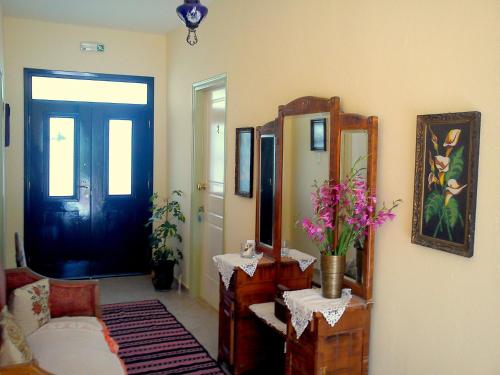 a living room with a mirror and a couch at Hariklia Rent Rooms in Zarós