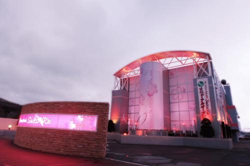 a large building with pink lights on it at Restay SaKuRa (Adult Only) in Hakodate