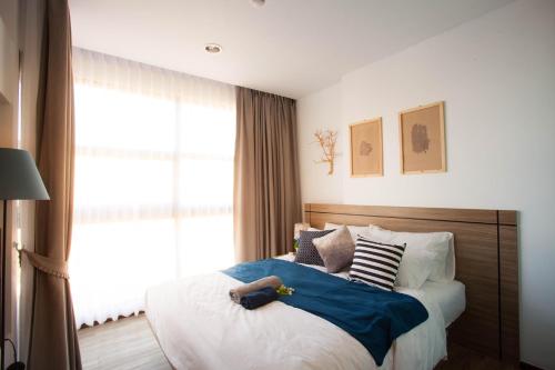 a small child laying on a bed in a bedroom at SimplyComfy Apartment by Patsamon in Pattaya South