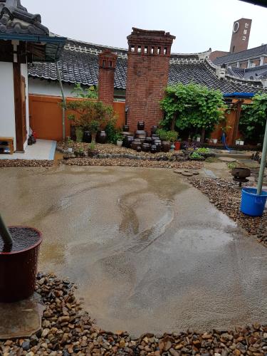 a yard with a concrete driveway in front of a building at The Hanok in Jeonju