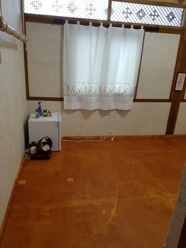 a room with a window and a white curtain at The Hanok in Jeonju