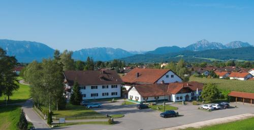 a village with cars parked in a parking lot at Hotel Oedhof in Freilassing