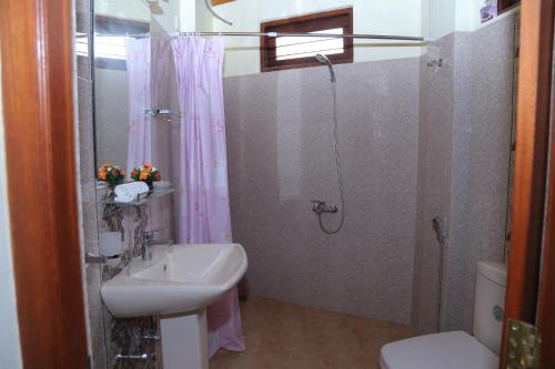 a bathroom with a sink and a shower at The Springfields Kandy Previously Madara Residence Kandy in Kandy