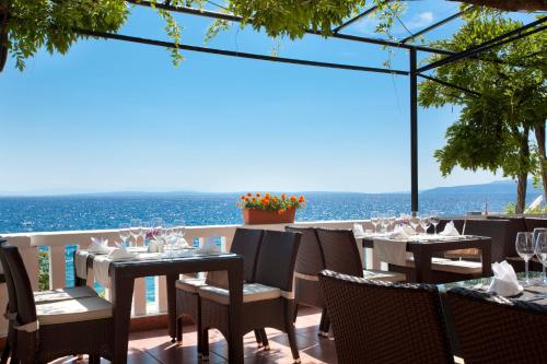 a restaurant with a view of the ocean at Hotel Kristal - Liburnia in Opatija