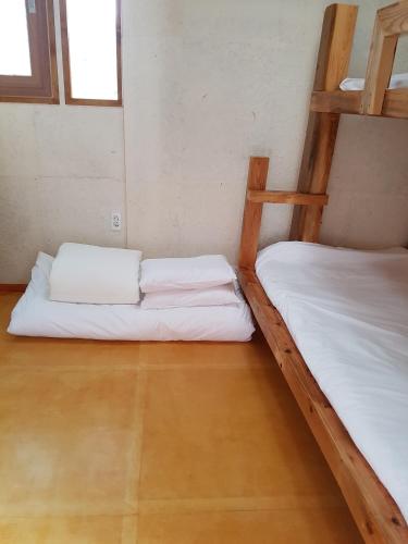 two bunk beds in a room with a wooden floor at The Hanok in Jeonju