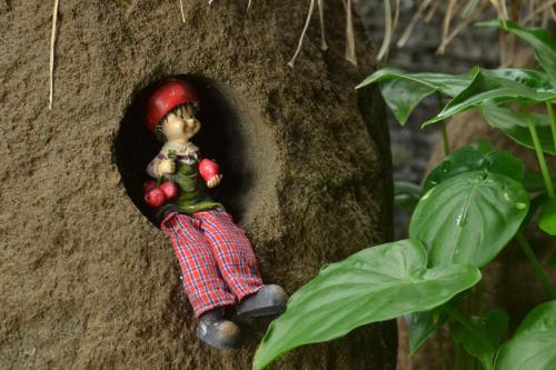 a small figurine of a person hanging from a tree at R7 Hotel in Kaohsiung