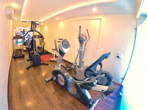a gym with two exercise bikes and a treadmill at Hotel Sepal in Bathinda