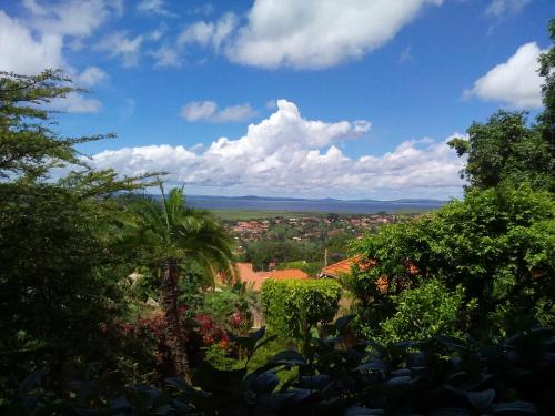a view of a city from a hill with trees at Retreat Guesthouse Kitende in Entebbe