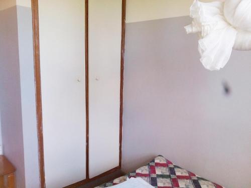 a bedroom with a mirror on the wall at Retreat Guesthouse Kitende in Entebbe