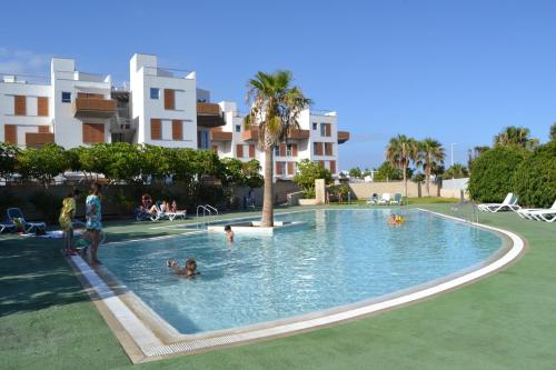 a group of people in a swimming pool at Alquilaencanarias-Medano Los Martines beachfront A in El Médano