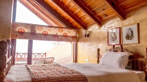 a bedroom with a bed and a large window at LaRiSa Homes X 1 Partridge Hill in Mukteswar