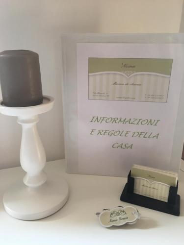 a white table with a cake and a box at Nzina Maison de Charme in Nicolosi