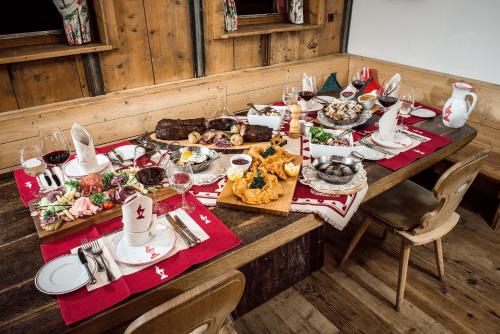 a table full of food on a wooden table at Rasmushof - Hotel Kitzbühel in Kitzbühel