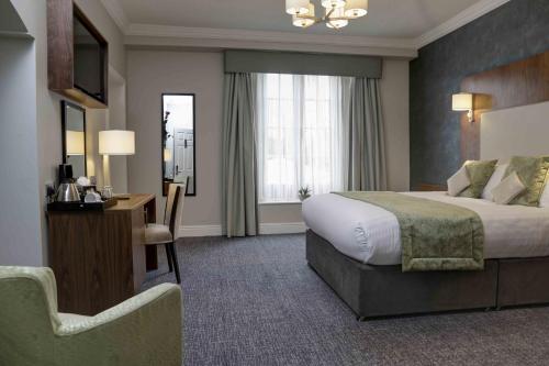 a hotel room with a bed and a chair at The Croft Hotel in Darlington