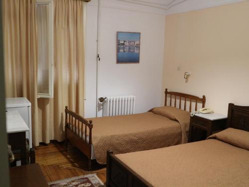 Postel nebo postele na pokoji v ubytování Acropolis House