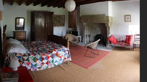 a bedroom with a bed and a fireplace at Manoir de la Guerrie in Saint-Patrice-de-Claids