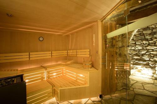 a room with a sauna with a stone wall at Hof Alpenjuwel in Nauders