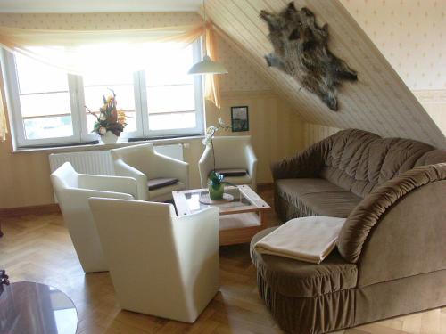 a living room with a couch and a chair at Feriendomizil am Hafen in Zingst