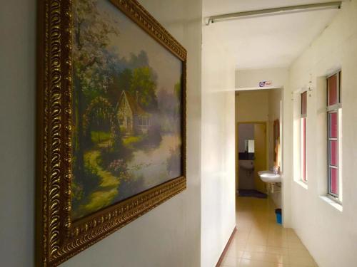 a painting hanging on a wall in a hallway at Georgetown Heritage Motel in George Town