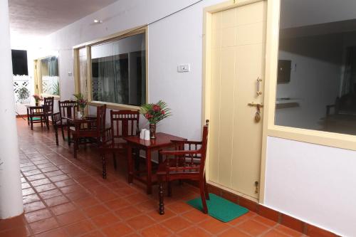 a row of tables and chairs in a restaurant at Meya Beach Walk Hotel in Mahabalipuram