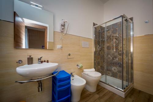 a bathroom with a sink and a toilet and a shower at Antico Canale in Castellammare del Golfo