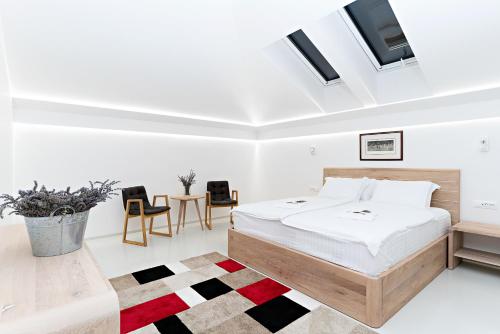 a bedroom with a bed and a table and chairs at BA Apartments in Sarajevo