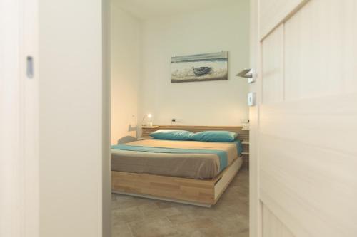 a bedroom with a bed and a painting on the wall at Villa Pomelia in Balestrate