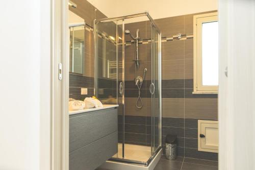 a shower with a glass door in a bathroom at Villa Pomelia in Balestrate