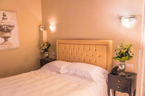 a bedroom with a white bed and two night stands at Hotel Patavium in Padova