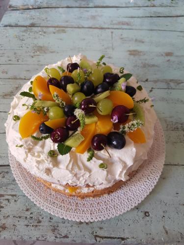 a cake with fruit on top of it on a table at Acquasale in Castrovillari