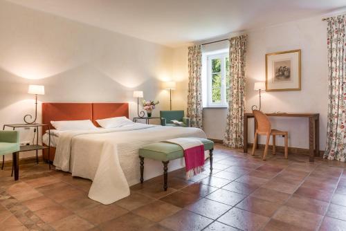 a bedroom with a bed and a table and chairs at Burg Heimerzheim in Swisttal