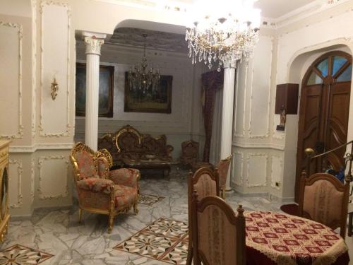 a living room with chairs and a chandelier at B&B San Cristofero in Valguarnera Caropepe