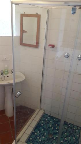 un bagno con doccia e lavandino di Sanfern Downs Cottage a Haenertsburg