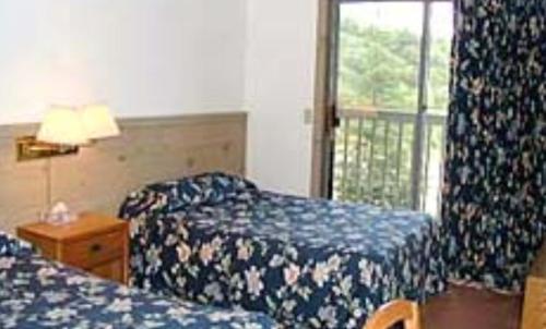 Cama o camas de una habitación en Austrian Haus Lodge