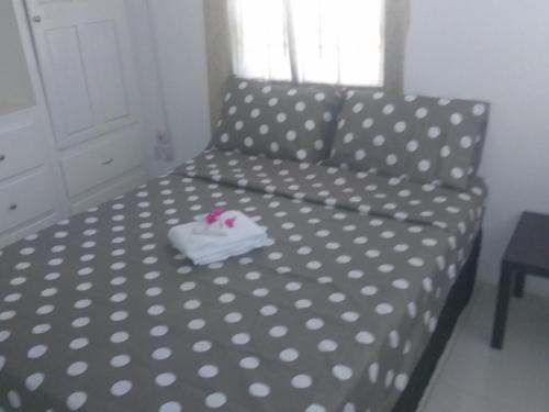 a polka dot couch with a white shirt on it at Caribbean Dream Vacation Property CD2 in Rodney Bay Village