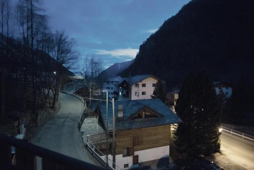 a building with a blue roof on a street at Hotel Etoile De Neige in Valtournenche