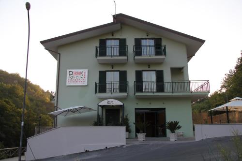 a white building with a sign in front of it at Palia's Hotel in Laino Borgo