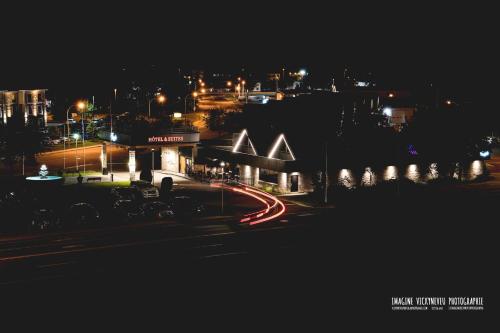 a city lit up at night with street lights at L'Escale Hôtel Suites in Val-dʼOr