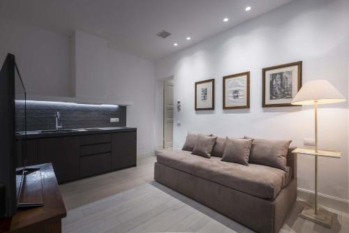 a living room with a couch and a sink at Mysuiteshome Apartments in Bologna