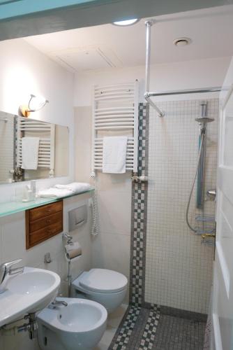 a bathroom with a shower and a toilet and a sink at Rooms Bytom in Bytom